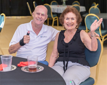 Golden-Years-Senior-Dance-couple-smiling-and-waving.png