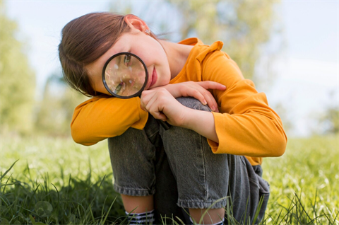 Girl holding magnifying glass