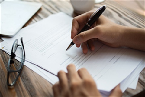 Businessman examining papers at table photo