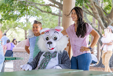 Eggstravaganza family taking photo with Easter Bunny