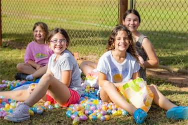 Eggstravaganza kids smiling with eggs and baskets