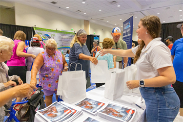 Hurricane Expo 2024 attendees receiving giveaway