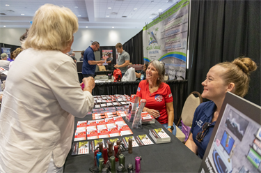Hurricane Expo 2024 attendees speaking with an exhibitor